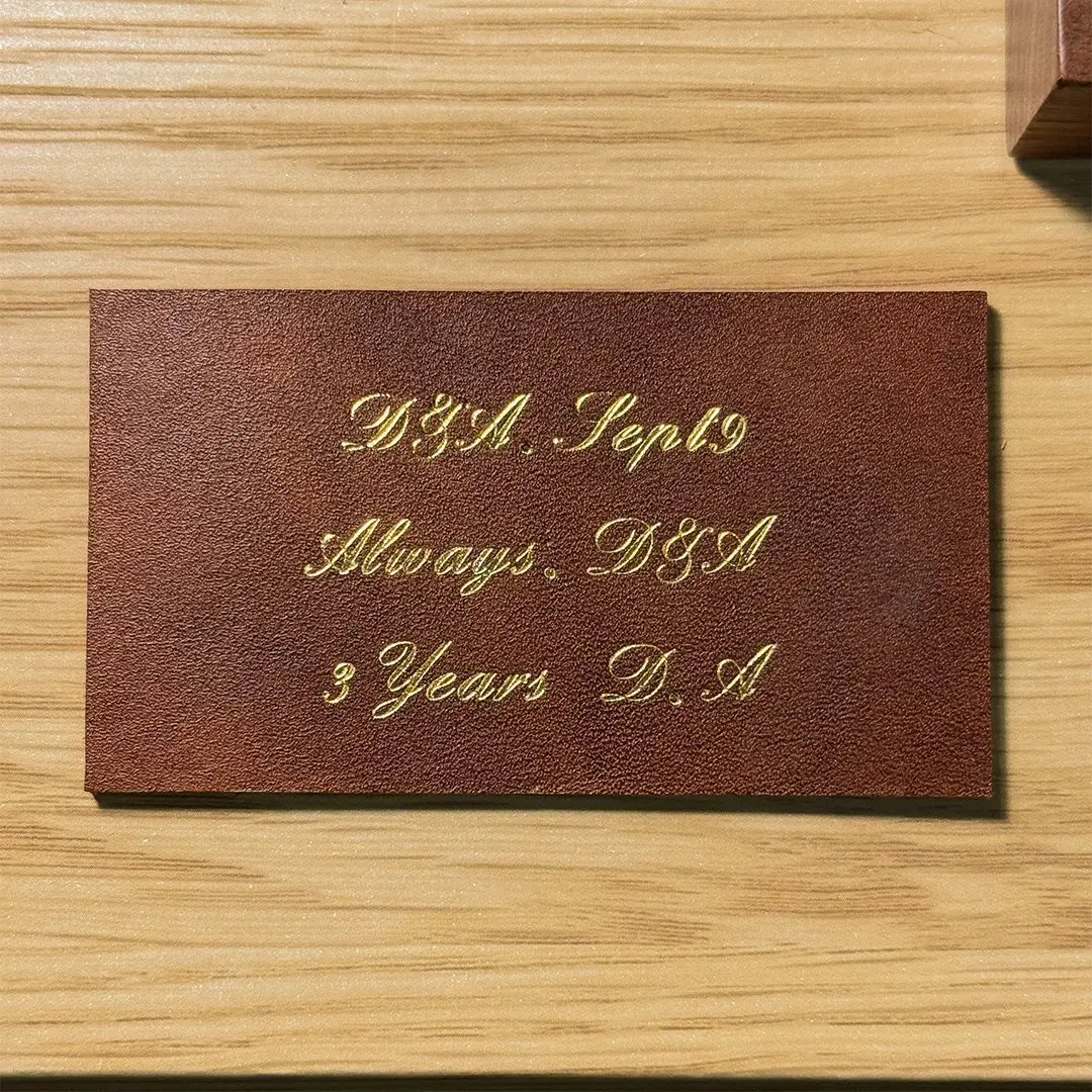 Custom gold foil embossing for a 3rd leather anniversary gift option, handcrafted by Longisland Leather in Calgary, Alberta.