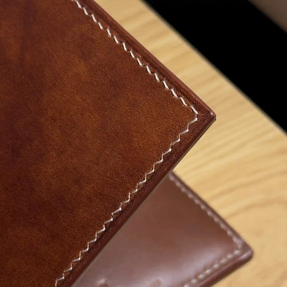 Close-up of the traditional hand saddle stitching on the classic bifold leather wallet.