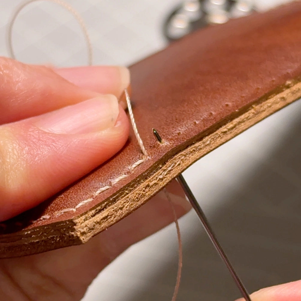 Crafting the classic men's wallet using traditional hand-finishing techniques.