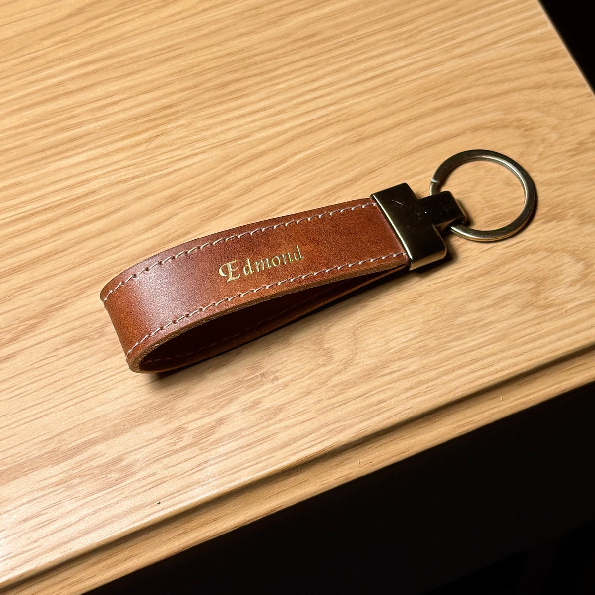 LOOP brown leather keychain with personalized gold name stamping and stitched edges