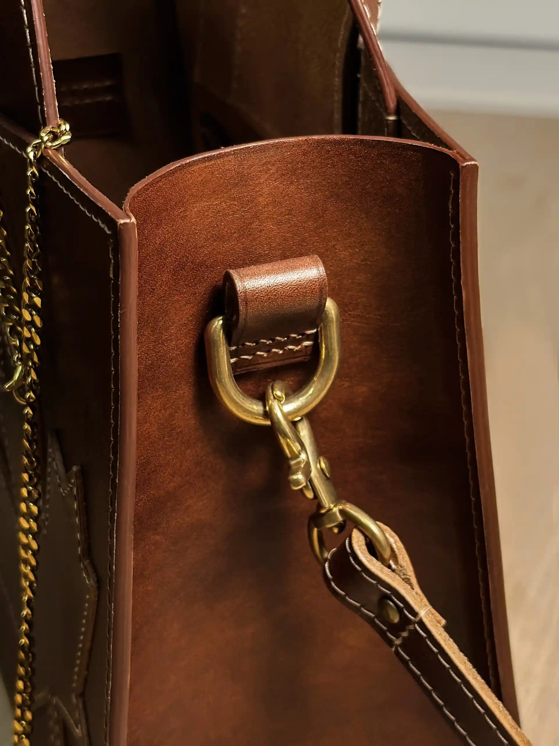 Side view of the Maple Heritage bag highlighting the durable leather edge paint and solid brass shoulder strap attachment