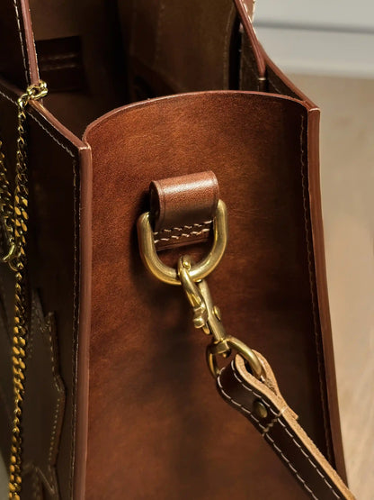 Side view of the Maple Heritage bag highlighting the durable leather edge paint and solid brass shoulder strap attachment