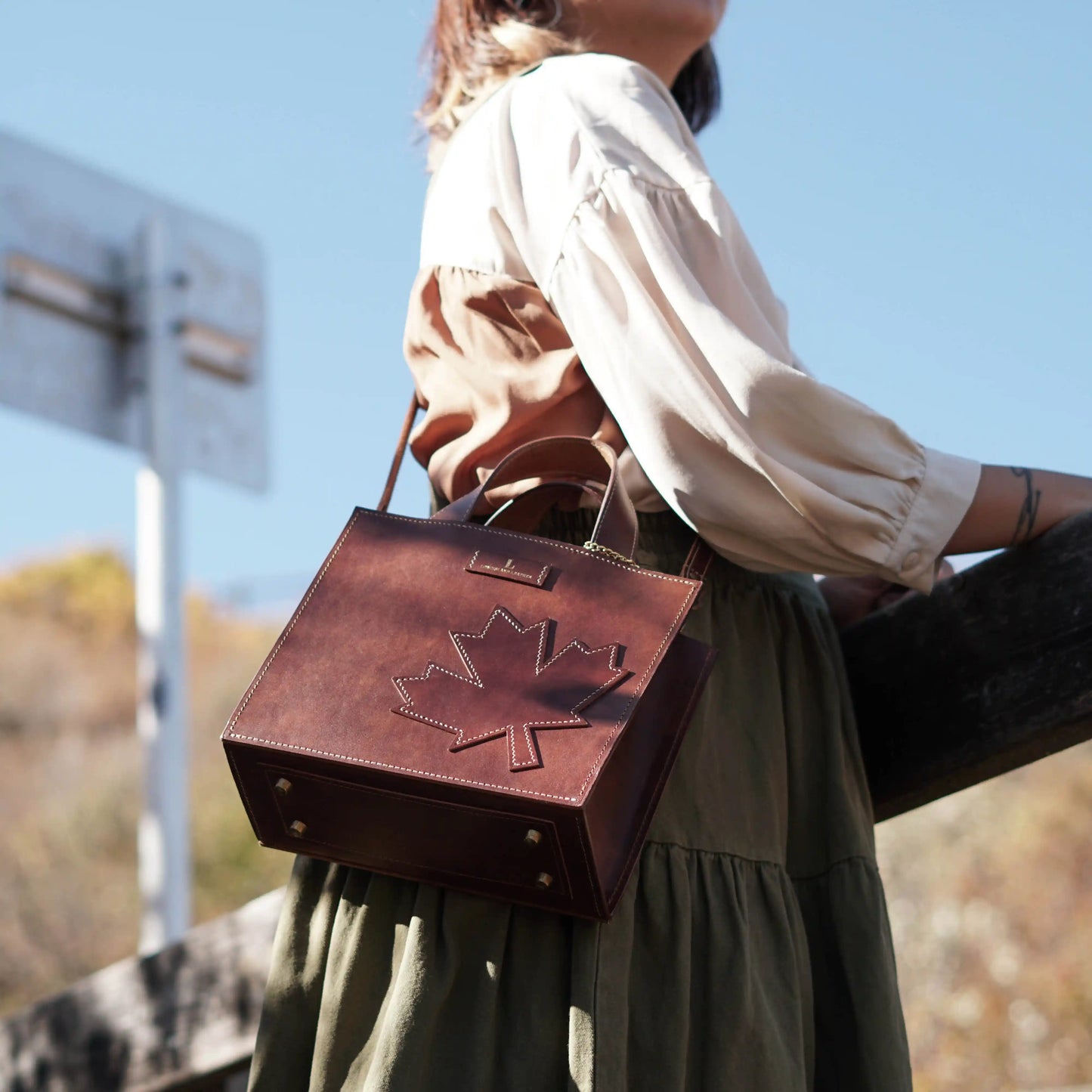 Side view of the handcrafted Maple leather bag being worn as a crossbody.