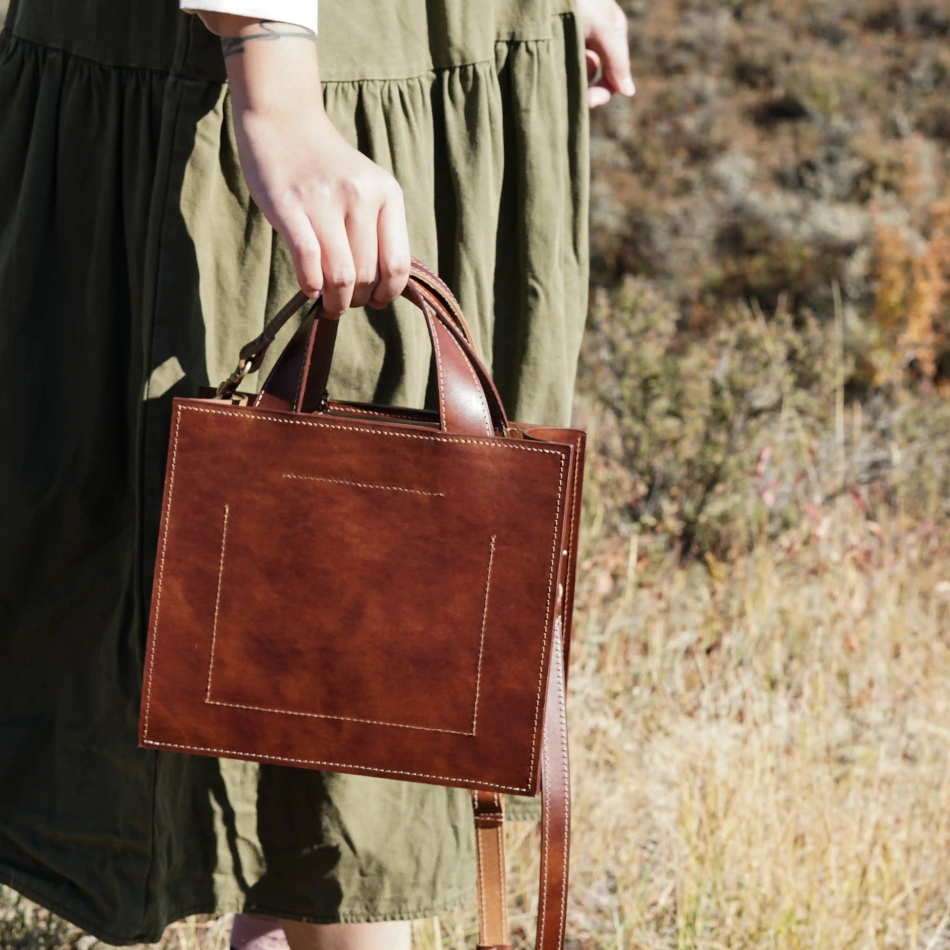 Back view of the Maple leather handbag, showing its smooth leather and stitching details
