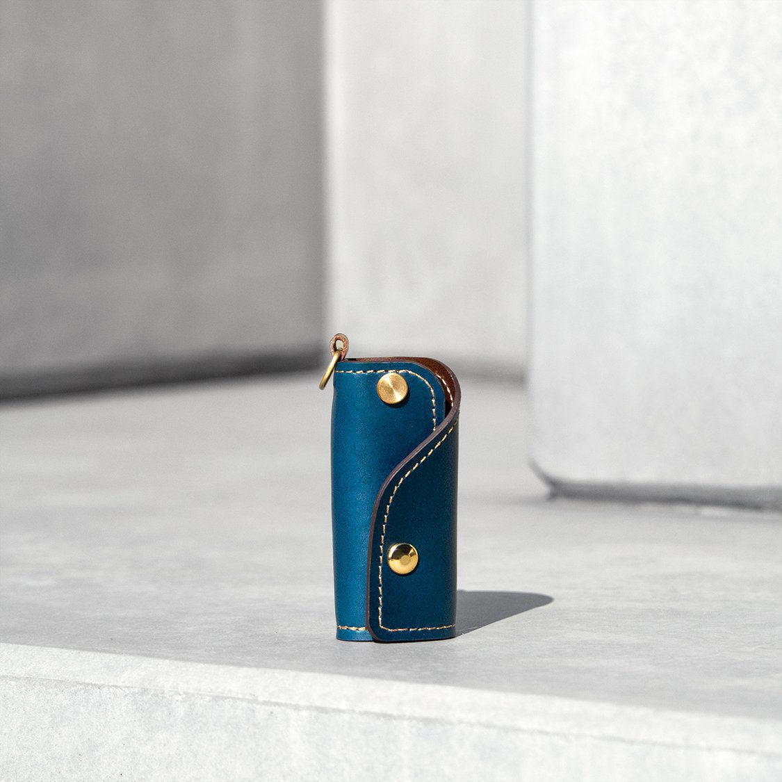 The SIDECAR custom leather key case in navy blue, a slim and durable key holder for personalized gifts