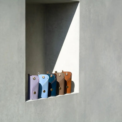 A collection of SIDECAR leather key organizers in various colors including Lavender, Blue, and Navy, handcrafted in Canada.