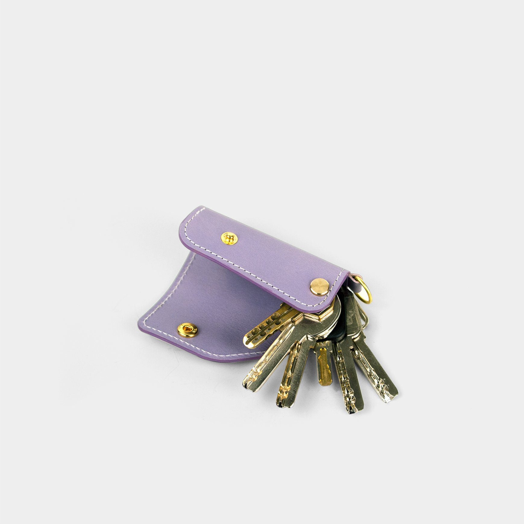 The SIDECAR leather key organizer in Lavender, showing 5 keys organized securely in a silent, sliding leather case.