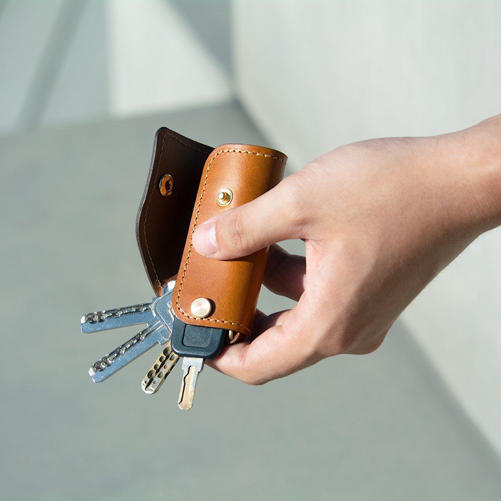 The SIDECAR personalized leather key organizer in Whiskey brown, showing 5 keys organized in a silent, sliding leather case