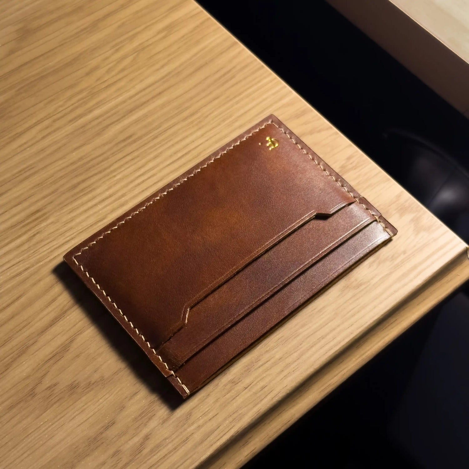 Diagonal view of a slim leather card holder showing multi-slot design and premium edge finishing.