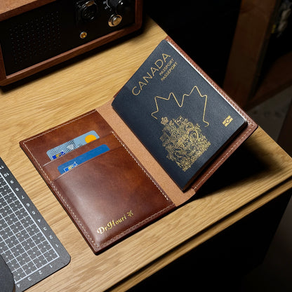 Open leather passport wallet with two card slots and gold name stamping